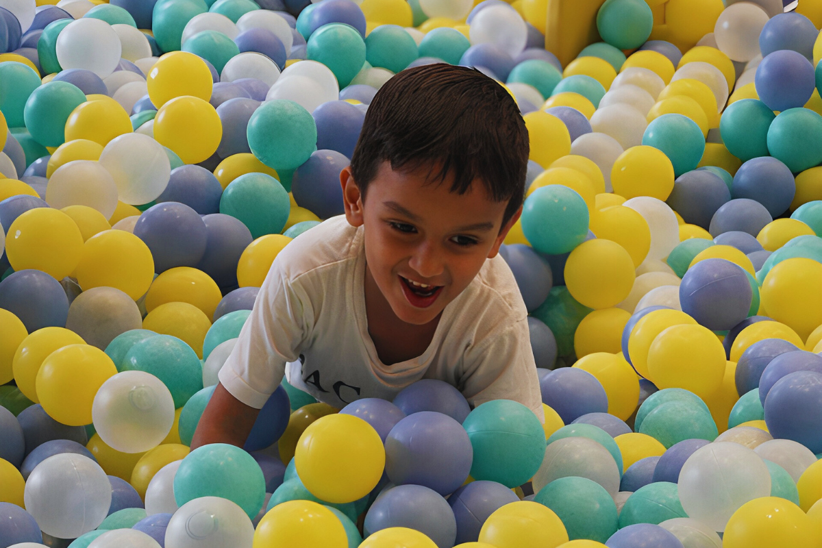 kid playing in the ball pit